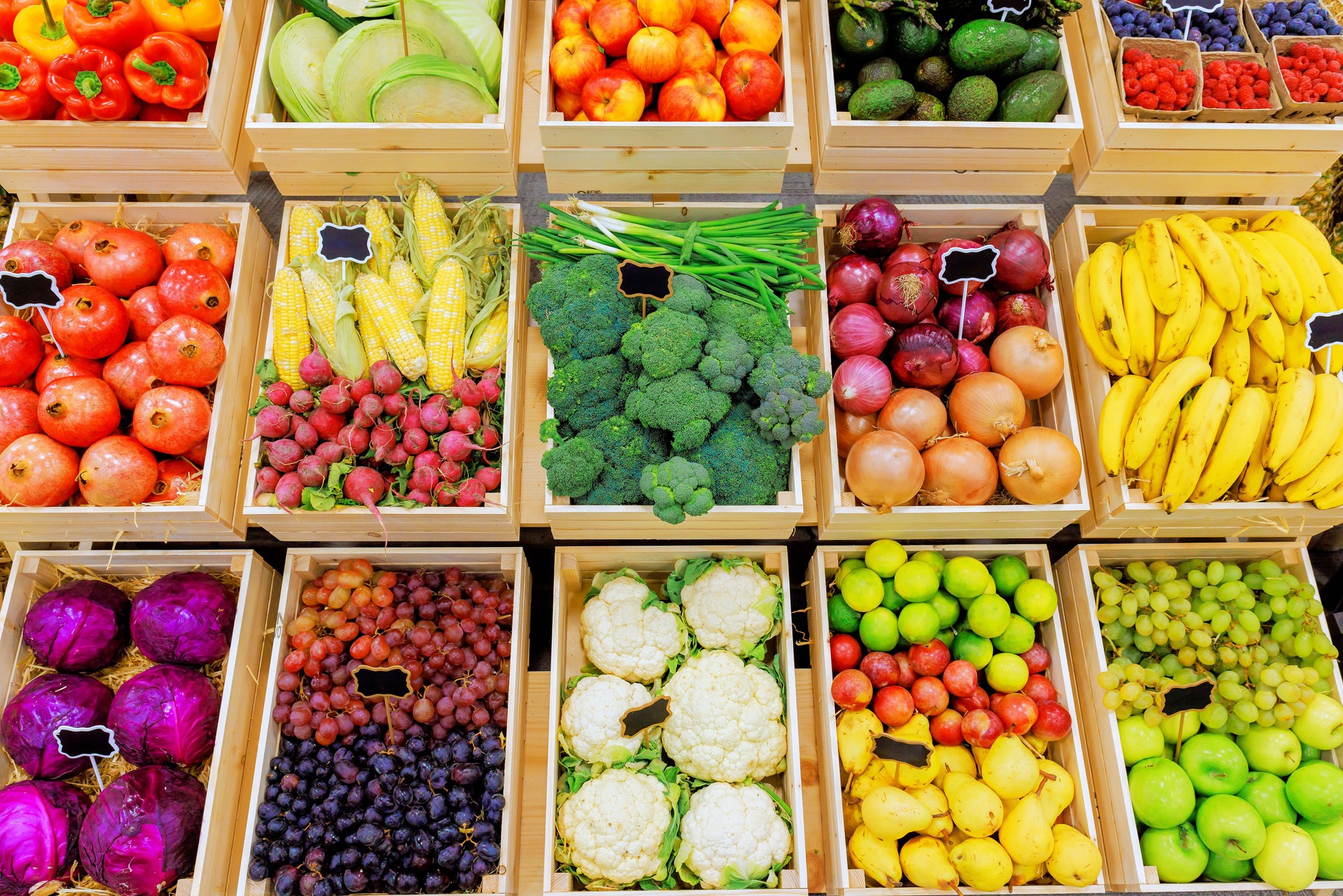 Colorful display of fresh fruits, vegetables in farmer market stall during day
